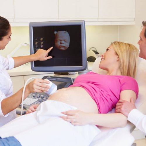 Pregnant Woman And Partner Having 4D Ultrasound Scan
